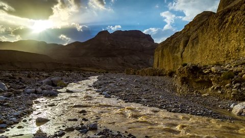 Streams in the desert - sunset over Judean Desert mountains, as the water streams down after the rains