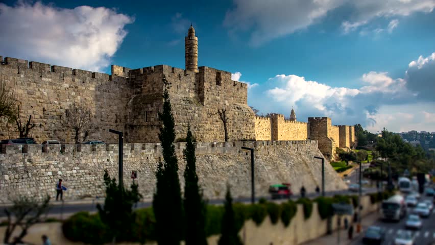 Time lapse of the Tower of David museum and the Ottoman-built fortified walls of the Old City, with clouds moving and the road leading upto Jaffa Gate; Jerusalem Israel