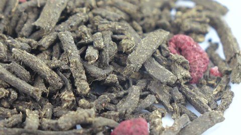 A pile of fermented tea with raspberries with raspberries