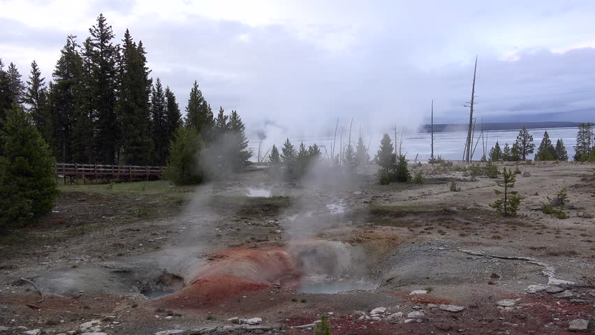 Twin Geysers in West Thumb Geyser Basin at dusk. Yellowstone NP, Wyoming, USA