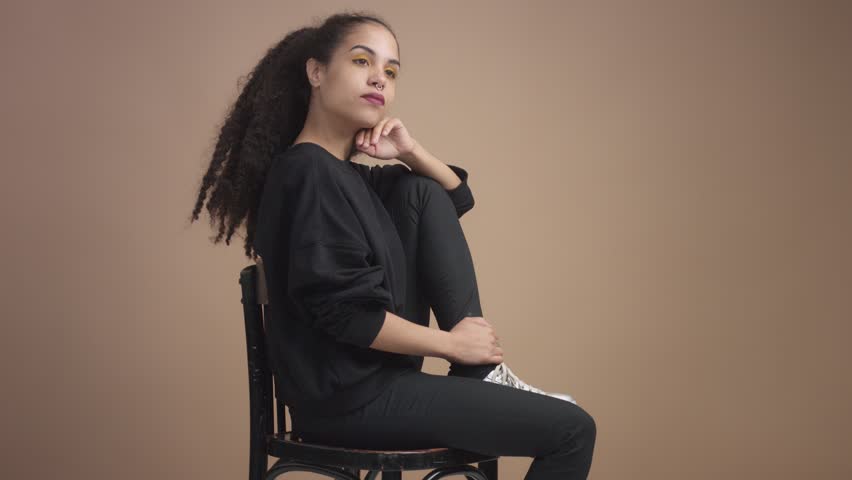 youg woman in studio in beige background