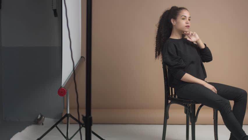 youg woman in studio in beige background