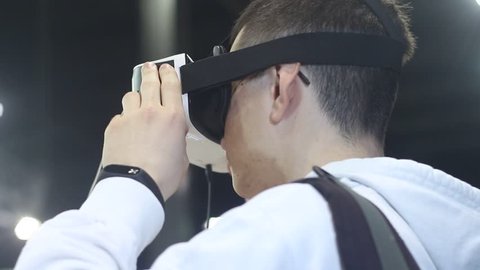  Man wearing virtual reality glasses looks around