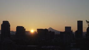 Ultra high definition 4k movie of sun rising over downtown city of Portland Oregon and snow covered Mt. Hood one early winter morning 3840x2160