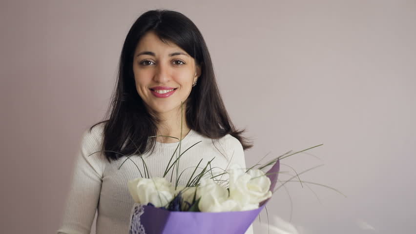 Closeup brunette young women portrait with bouquet. Happy  girl  gets  flowers.  Royalty-Free Stock Footage #1008615856
