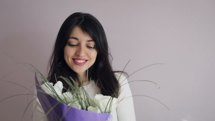 Closeup brunette young women portrait with bouquet. Happy  girl  gets  flowers.  Royalty-Free Stock Footage #1008615862