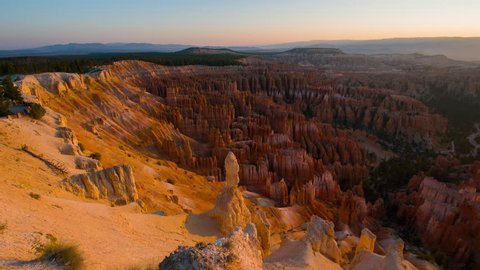 Rays of the sun illuminates orange cliffs. Panoramic view at the cliffs. Nature video. Amazing mountain landscape. Bryce Canyon National Park. Utah. USA. 4K, 3840*2160, high bit rate, UHD