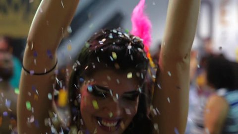 Woman Dancing and Celebrating with Confetti at Brazilian Carnival, Salvador, Bahia