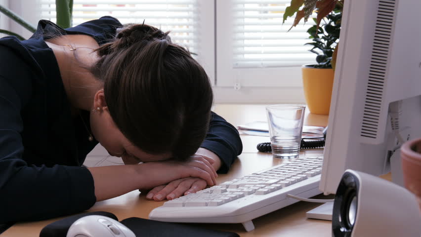 Overtime - young woman is exhausted and frustrated at the office. Home office, teleworking, remote work work | Shutterstock HD Video #1008632671