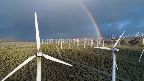 Aerial drone shot of a rainbow over the wind turbines in the San Gorgonio Pass by Palm Springs, California. 