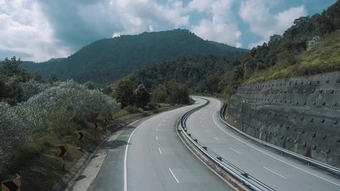 An aerial footage of empty road in the tropical forest somewhere in Malaysia.