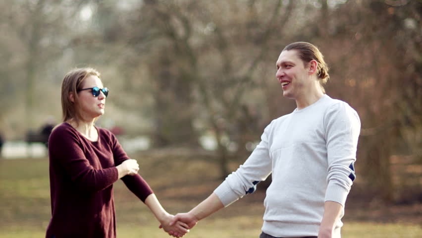 A guy and a girl are hugging in a spring park. Early spring, meeting of lovers