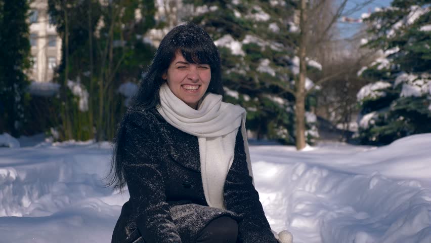Happy Pretty Girl Throws Snow In Air. Snow Covered Park. Winter City Life. Slow Motion 30 fps 1/2 real time speed 60 fps