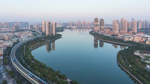Timelapse - Aerial View of Lakeside Reservoir with Modern Building Background, Xiamen, China