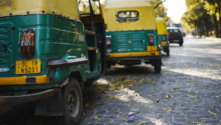 Delhi, India 2017. Rickshaws parked along the road.