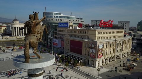 SKOPJE, MACEDONIA - OCTOBER 2017: Static drone shot of Alexander the Great statue and Coca Cola commercial advertising on classic building in Skopje, Macedonia