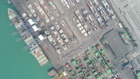 Video Container ship in export and import business and logistics. Shipping cargo to harbor by crane. Water transport International. Aerial view