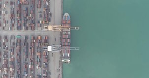 Video Container ship in export and import business and logistics. Shipping cargo to harbor by crane. Water transport International. Aerial view