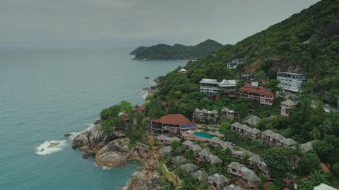 Thailand sea islalnd beach houses drone flight, wild mountains nature tree and palm hotel resort