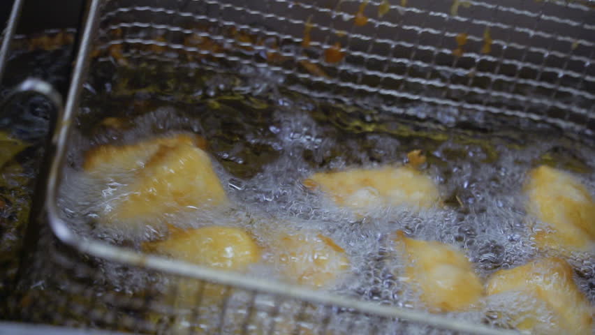 Cubes of tofu fries in hot oil