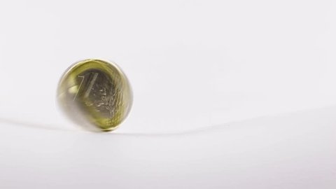 1 Euro coin spinning, rolling and dropping on white background