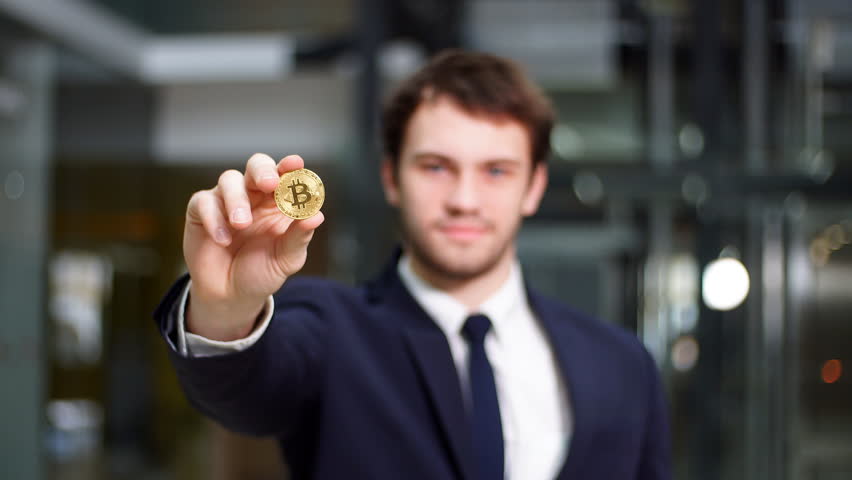 Man holding in hand symbol of bitcoin crypto currency - electronic virtual money for web banking.