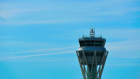 Barcelona Airport Radar Traffic Control Tower. Air Traffic Control Tower at Barcelona Airport with flying plane in sky.
