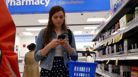 Coquitlam, BC, Canada - March 10, 2018 : Motion of people picking up for their medicine at pharmacy section inside Walmart store with 4k resolution