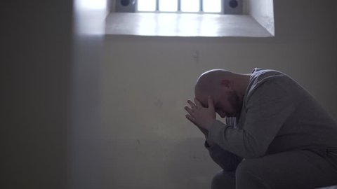 Prisoner Alone In Dark Cell, Cinematic Silhouette. Incarceration In Modern Prison, 4K Inmate Locked Up.