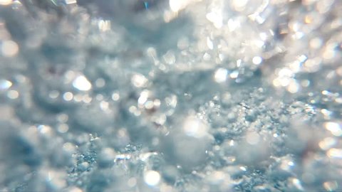 Professional video of blue underwater bubbles rising to surface in slow motion 250fps