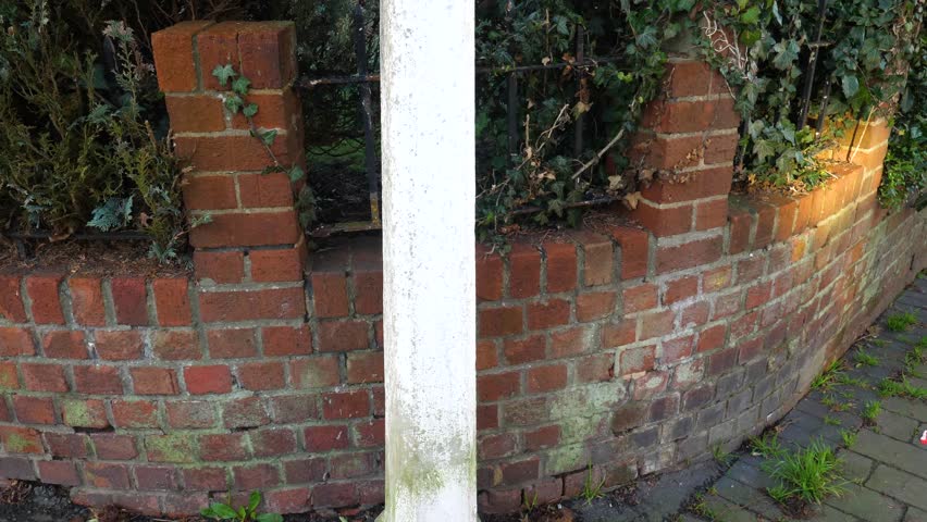 Establishing tilt shot of a Bristol sign on a street corner on a clear summer day