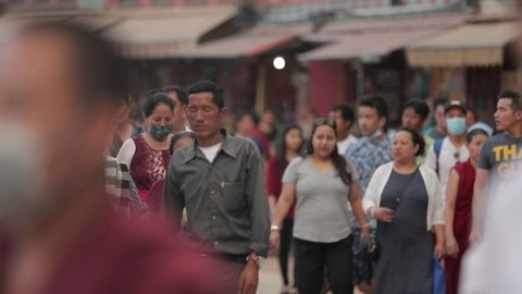 KATHMANDU, NEPAL - 29 May 2017: People of Nepal cityscape market street Durbar Square kathmandu boudhanath stupa. Crowd of people walking on busy street in Tibet,Population explosion, population growt