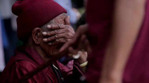 TIBET, KATHMANDU, NEPAL - 15 JANUARY 2017: Tibet Nepal Kathmandu Buddhist monks pray Buddhism Tibetan monastery temple. Woman spinning prayer wheels at the Boudhanath Stupa.