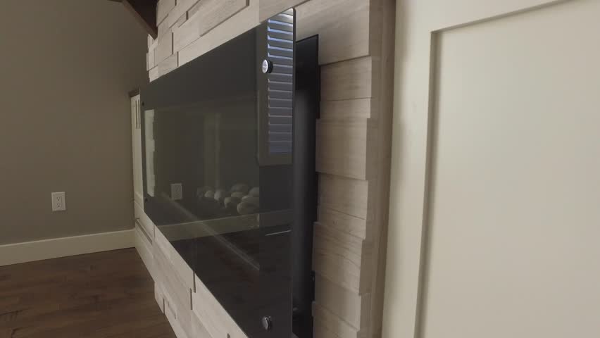 real estate modern brick work around fireplace and tv 4k rising gimbal view