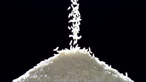 slow motion of falling rice on black background
