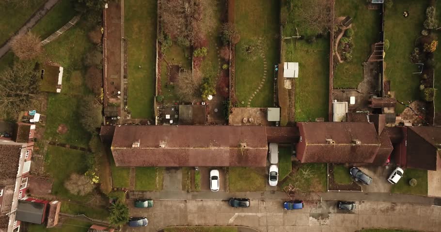 Aerial drone footage over residential buildings in Guildford on a sunny day.