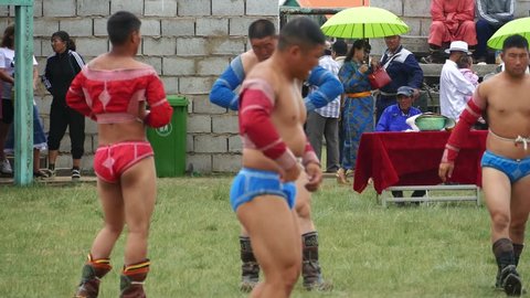 Telmen-sum, Mongolia - July 15, 2017: Mongolian national holiday Naadam. Wrestlers compete against each 

other in an open stadium.  Editorial use.