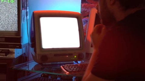 Man using an old Apple iMac computer