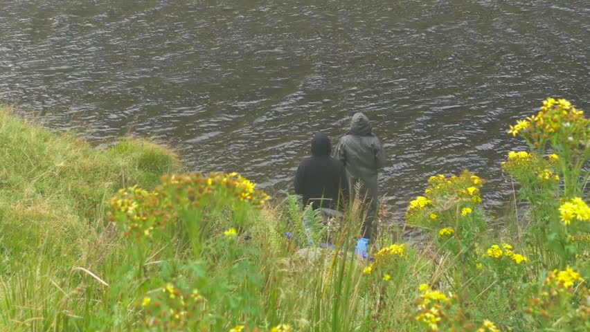 People on lakeside in Scottish Highlands