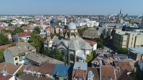 NOVI SAD, SERBIA - OCTOBER 2017: Aerial view flying over Jewish synagogue towards Catholic and Orthodox church in Novi Sad, Serbia