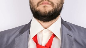 Businessman arranging his tie in front of the camera. Close up shot of unrecognisable person