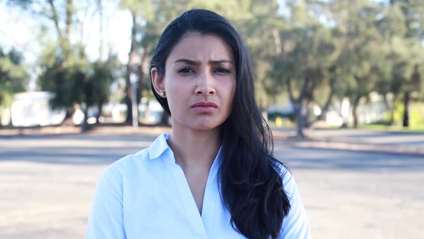 Closeup portrait of angry woman with blue button down shirt, isolated outside outdoors background. Negative emotion facial expression feeling Royalty-Free Stock Footage #1008718145