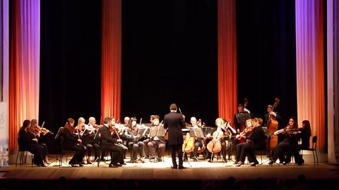 DNIPRO, UKRAINE - MARCH 12, 2018: FOUR SEASONS Chamber Orchestra - main conductor Dmitry Logvin perform St. Paul's Suite  by Gustav Holst at the State Drama Theatre.