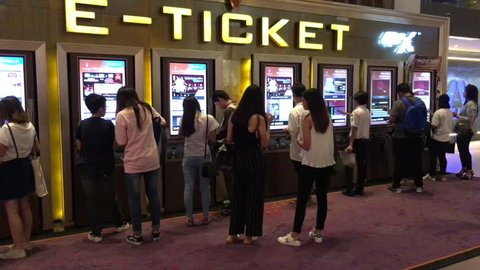 BANGKOK - DECEMBER, 2017: Young people buy e tickets at Krungsri IMAX Theater (Paragon Cineplex) in the Siam Paragon shopping mall.