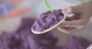 little girl plays with kinetic sand