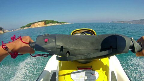 Jetski sport race pov. Tourism and recreation is main source of income to Corfu island. Beautiful clear green water.
