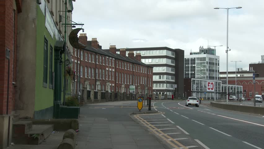 The curving road and buildings of the historic but tired looking Salford Crescent in the North of England.