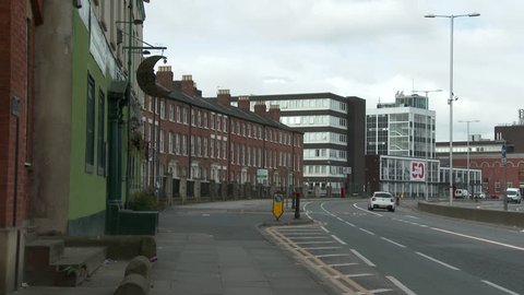 The curving road and buildings of the historic but tired looking Salford Crescent in the North of England.