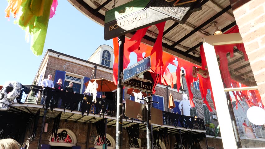 Festive red bunting on a building in Bourbon Street New Orleans Louisiana zooming in on the Bourbon St street sign