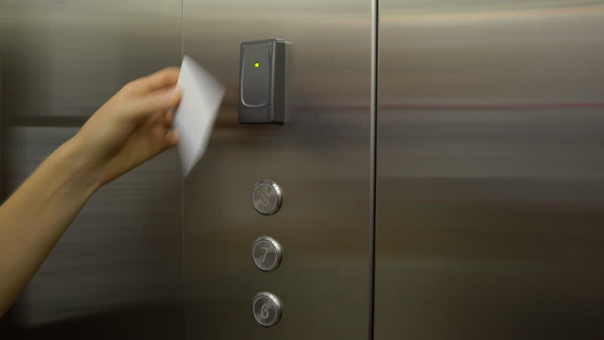 woman attach his plastic key card in elevator in order to unlock ability to enter his floor Royalty-Free Stock Footage #1008732059